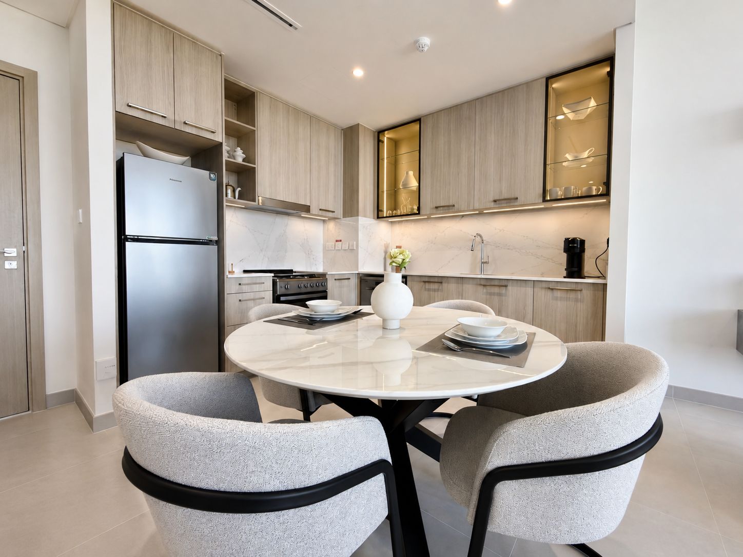 Staged Dubai dining area with marble table and bouclé chairs